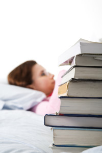 girl in bed with books