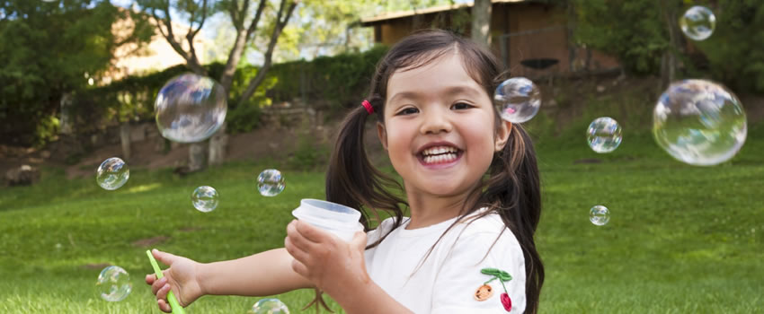 girl blowing bubbles