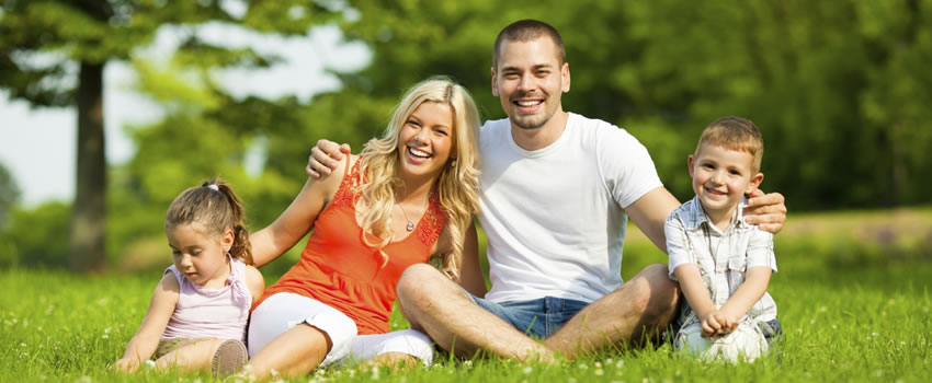 family sitting in grass